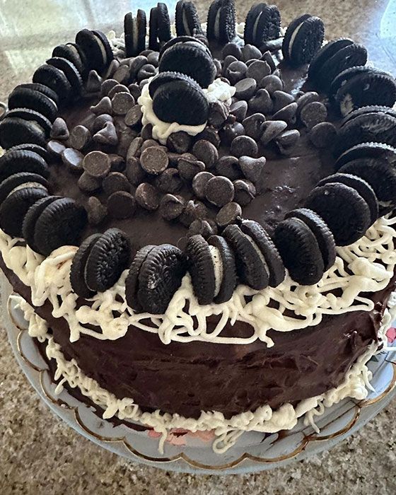 A large chocolate cake with lots of Oreos on top
