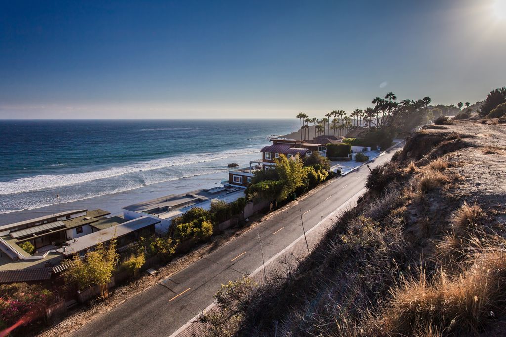 Pacific Ocean, road and houses located by the beach in Malibu.
