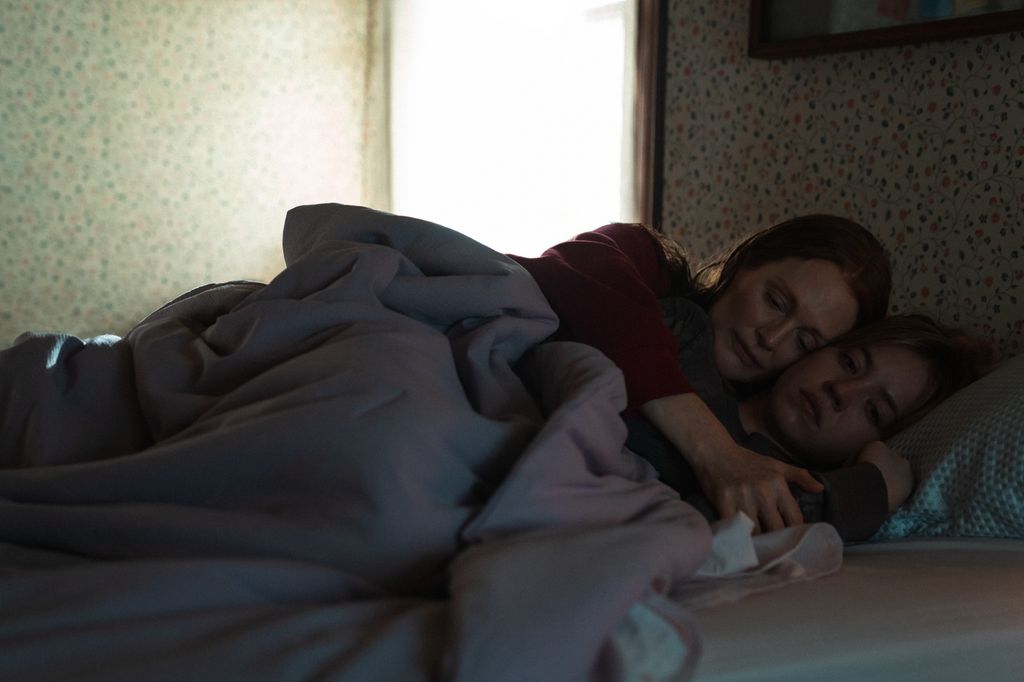 two women cuddling in bed