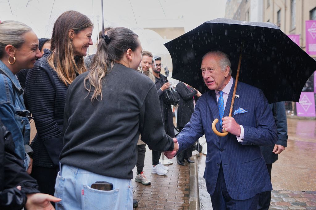 The King greeting fans in the rain at Spitalfields Market