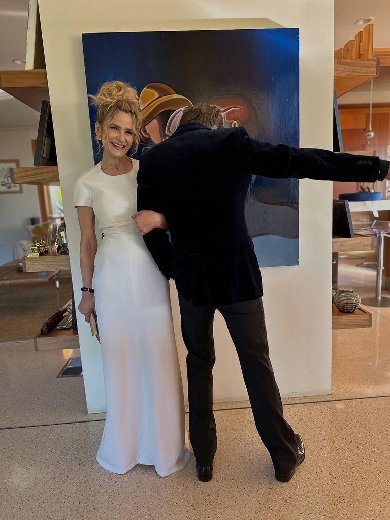 Kyra and Kevin at home in room with artwork on wall