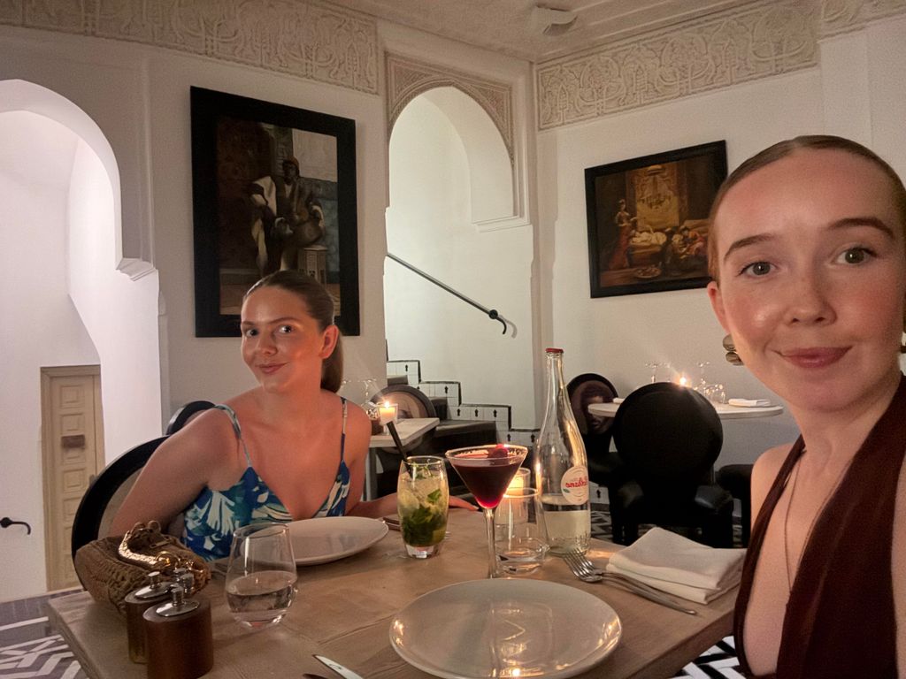 Two girls at a dinner table 