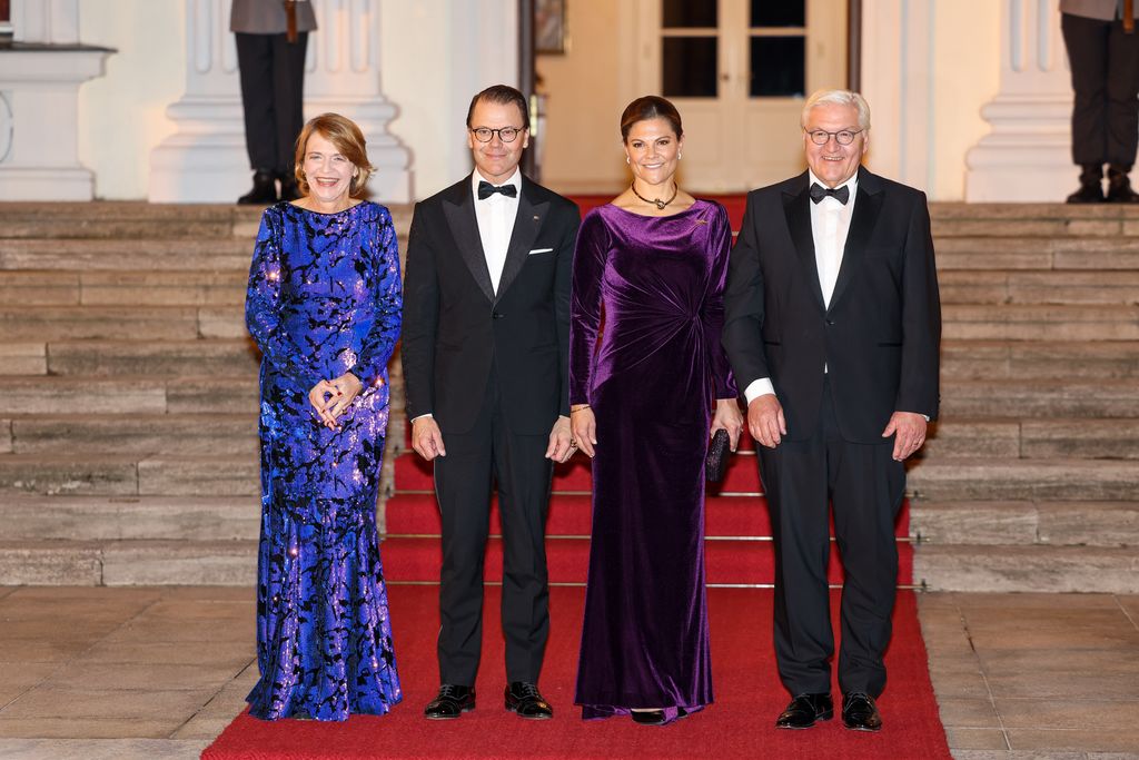 Victoria, Crown Princess of Sweden in line up of people in purple velvet dress