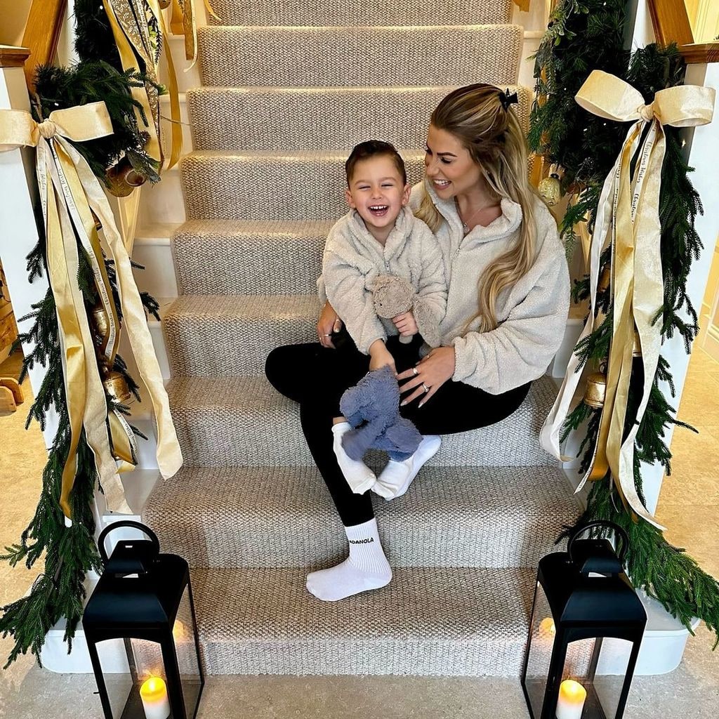 Sophie Hinchliffe sitting on the stairs with her son Ronnie