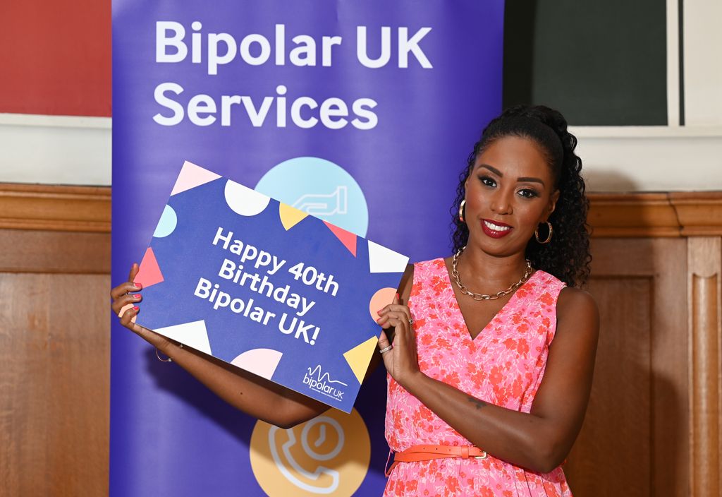 A photo of Leah Charles-King holding a Bipolar UK sign