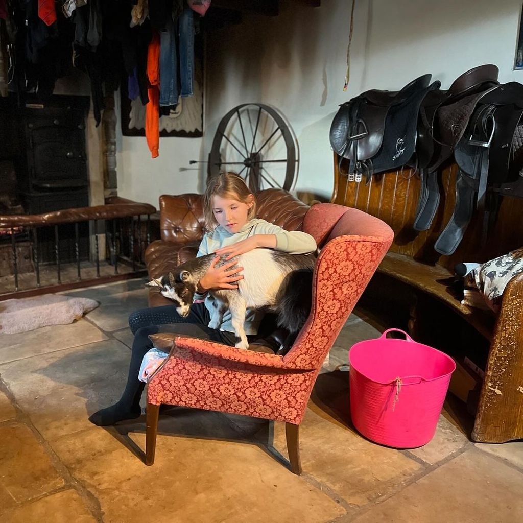 Amanda Owen's daughter cuddling her goat