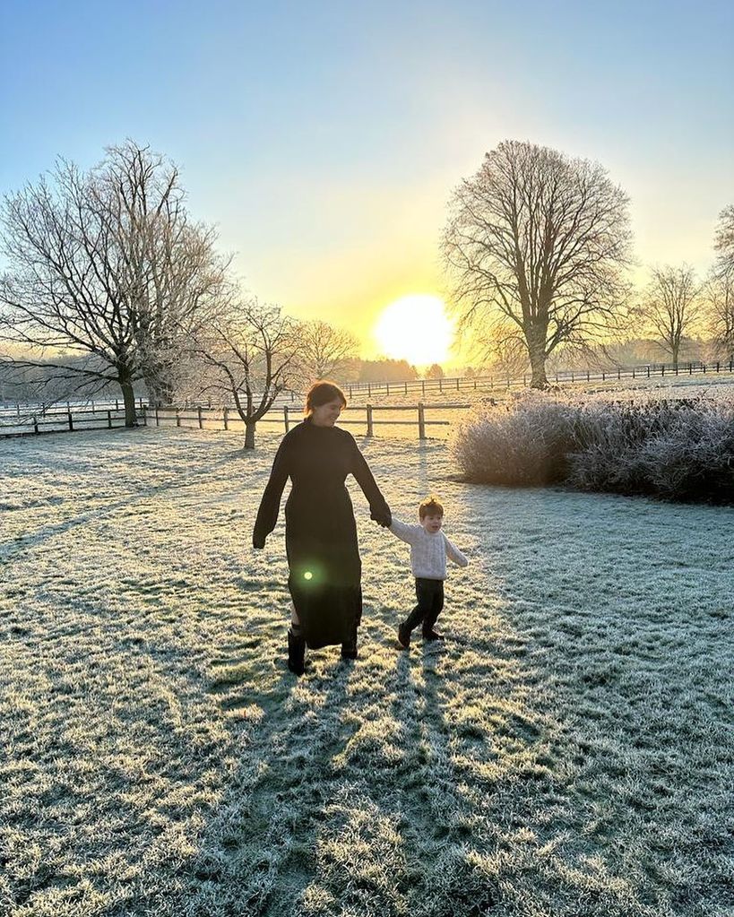 Princess Eugenie and her son August walking hand-in-hand through a frosty field