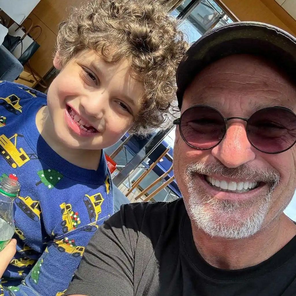 photo of howie mandel and grandson axel smiling