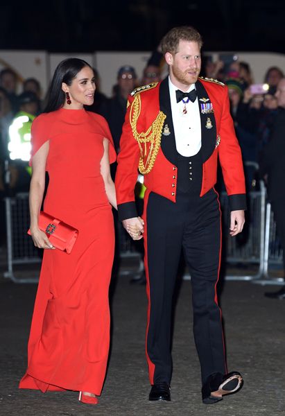 Prince Harry and Meghan Markle holding hands full length