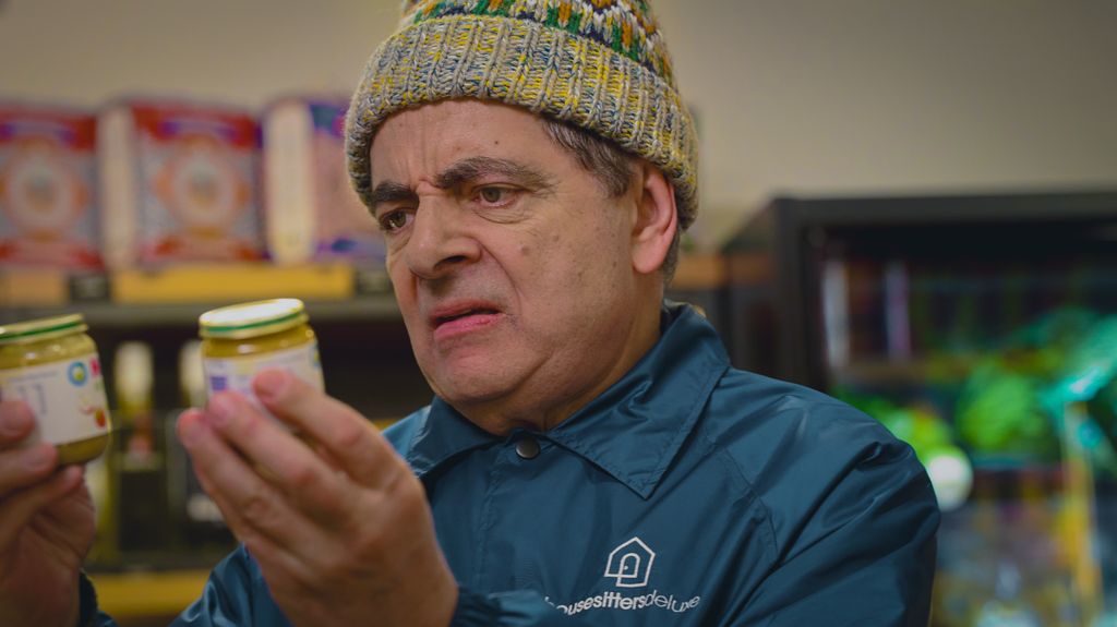 man holding jars of baby food