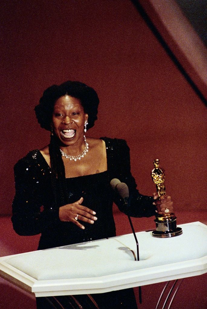 (Original Caption) Los Angeles: Whoopi Goldberg holds her Best Supporting Actress Oscar for her role in Ghost March 25.
