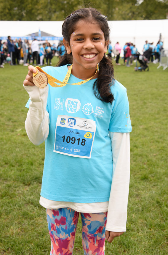 little girl holding medal