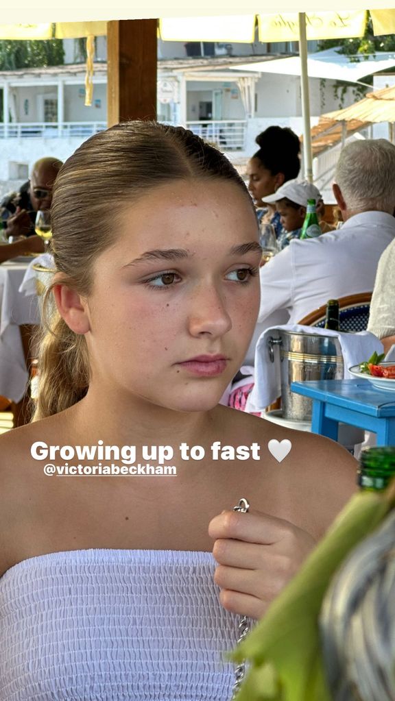 Harper Beckham sitting at the dinner table on holiday