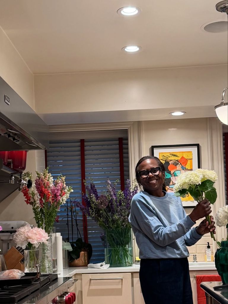 Deborah in the kitchen with flowers