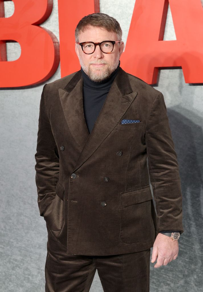 Guy Ritchie in a brown suit