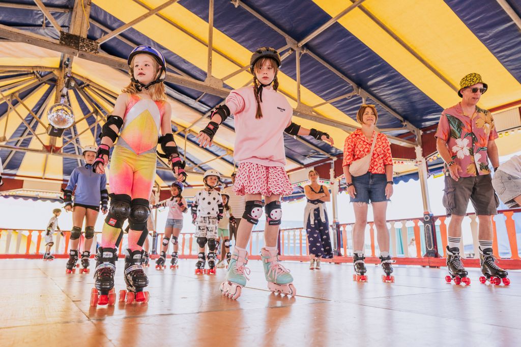 Children roller skating on a rink