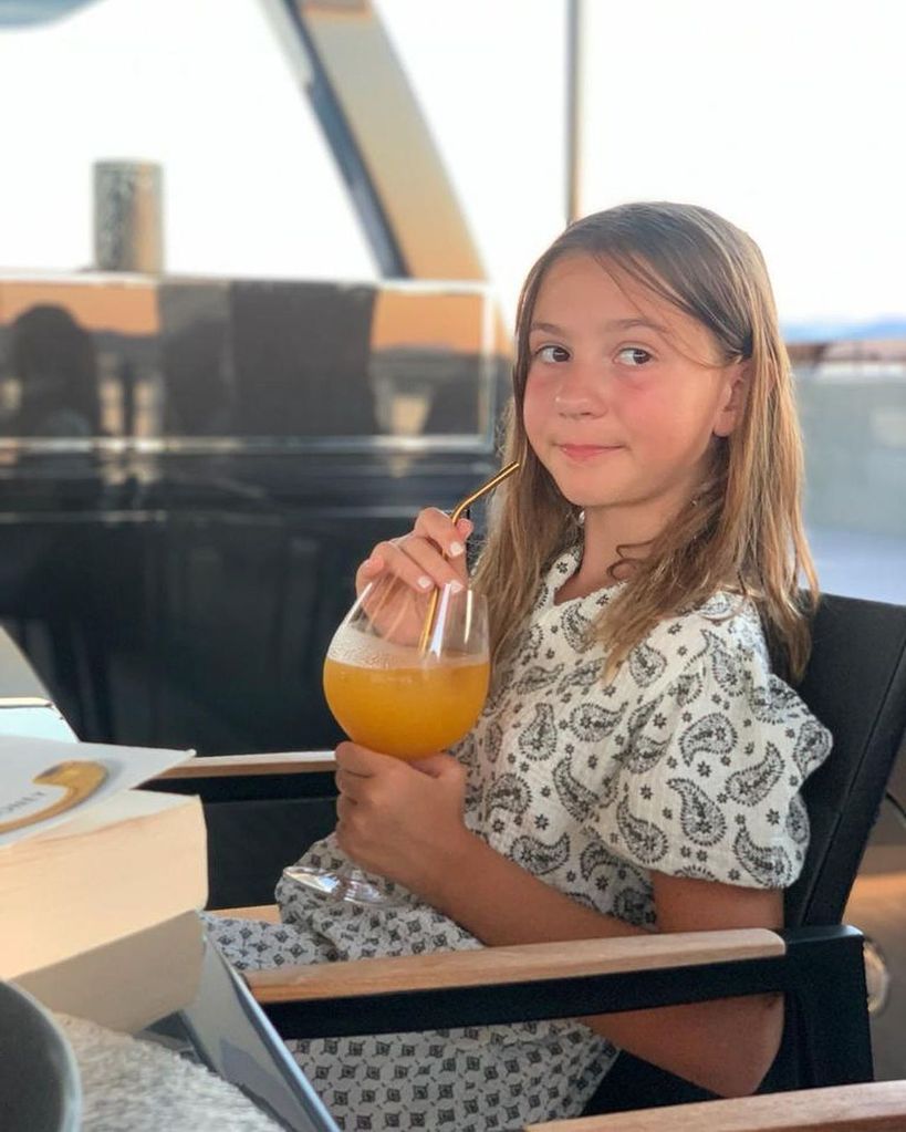 olivia sipping juice on boat 