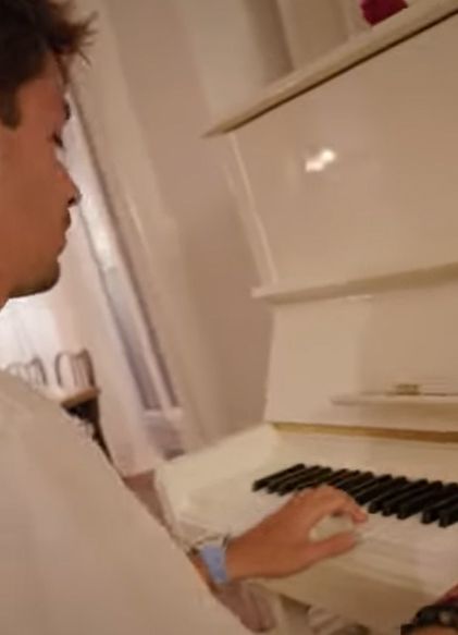 Charles Leclerc playing a white grand piano