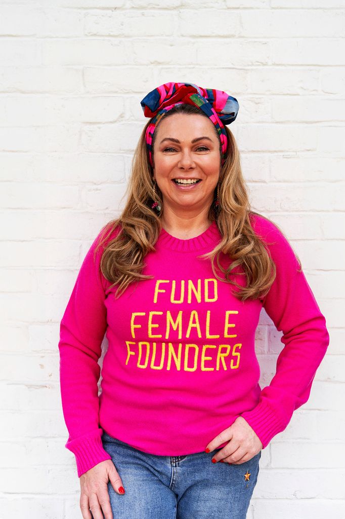 woman smiling in a bold pink jumper