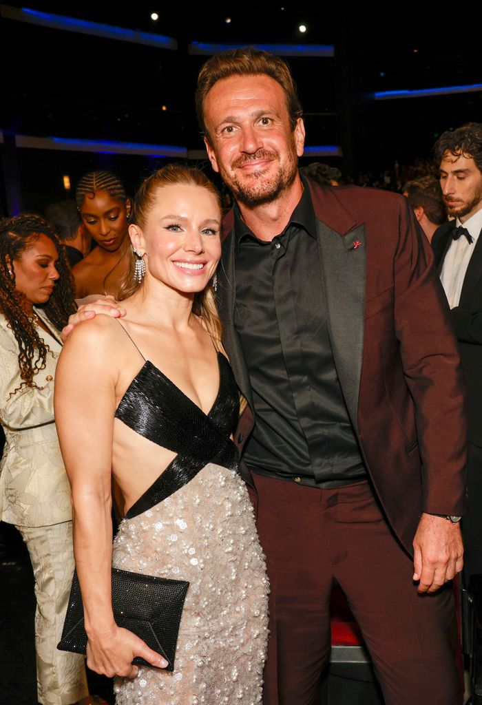 man and woman posing in crowded room