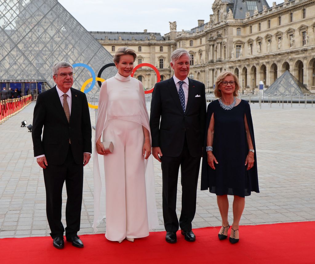 President of the International Olympic Committee (IOC) Thomas Bach (L) and his wife Claudia Bach (R) pose with Queen Mathilde of Belgium and King Philippe - Filip of Belgium upon their arrival at the Pyramide du Louvre