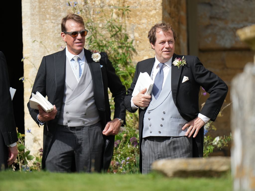 Tom appeared to be one of the bridal party members, standing with order of services at the entrance 