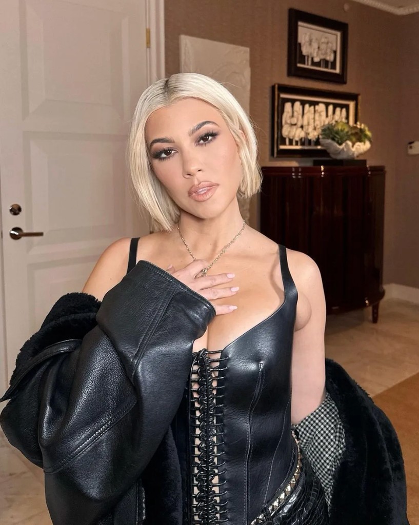 Kourtney Kardashian with blonde hair in all-leather outfit