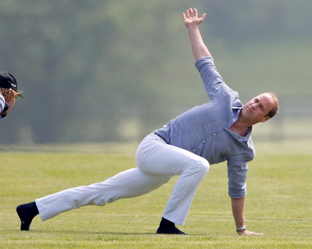 Prince William warms up before talking part in the Audi Polo Challenge at Coworth Park Polo Club