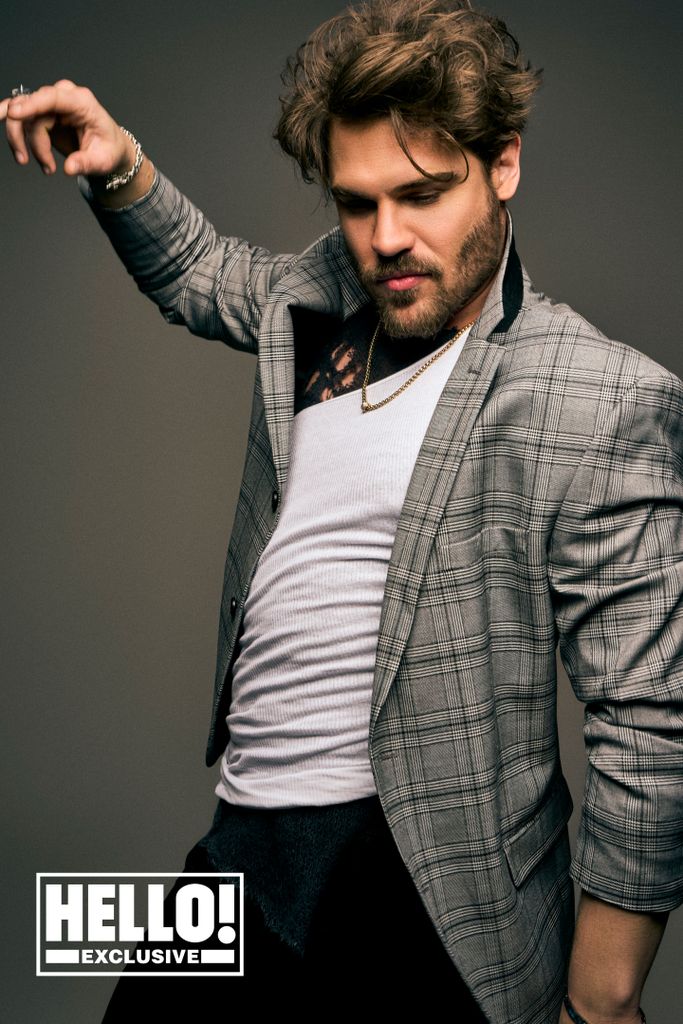 Grey Damon pulls a pose as he is photographed