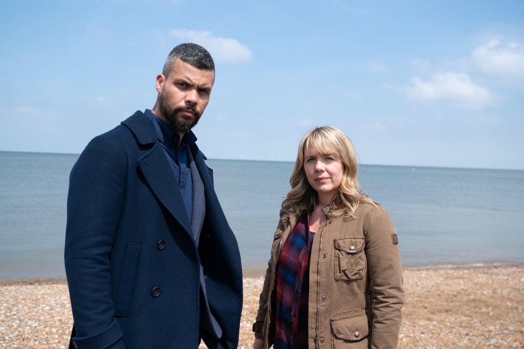 man and woman standing on beach
