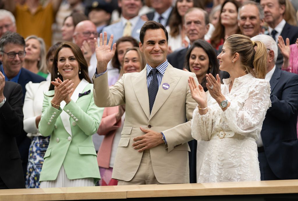 Roger Federer acknowledges the crowd with Catherine, Princess of Wales and his wife Mirka Federer