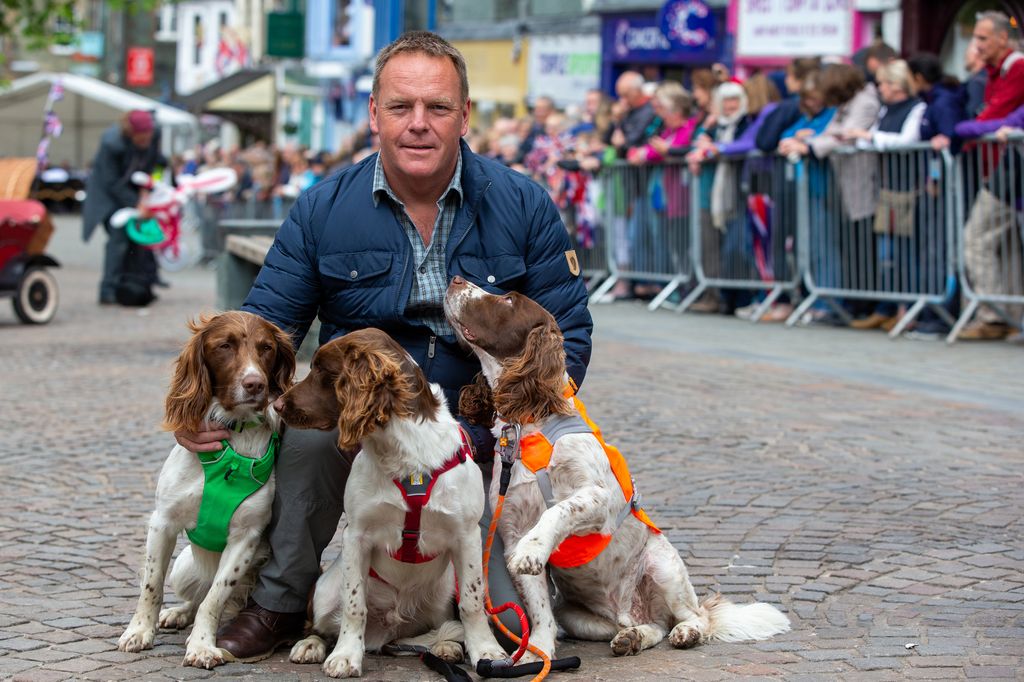 Kerry Irving poses with his three dogs Max, Paddy, and Harry after he met Prince William, Duke of Cambridge and Catherine, Duchess of Cambridge as they visit Keswick Market place during a visit to Cumbria on June 11, 2019 in Keswick, England