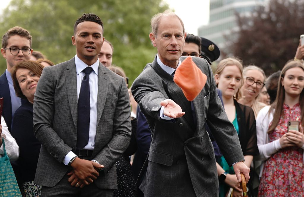 Prince Edward playing cornhole in a suit