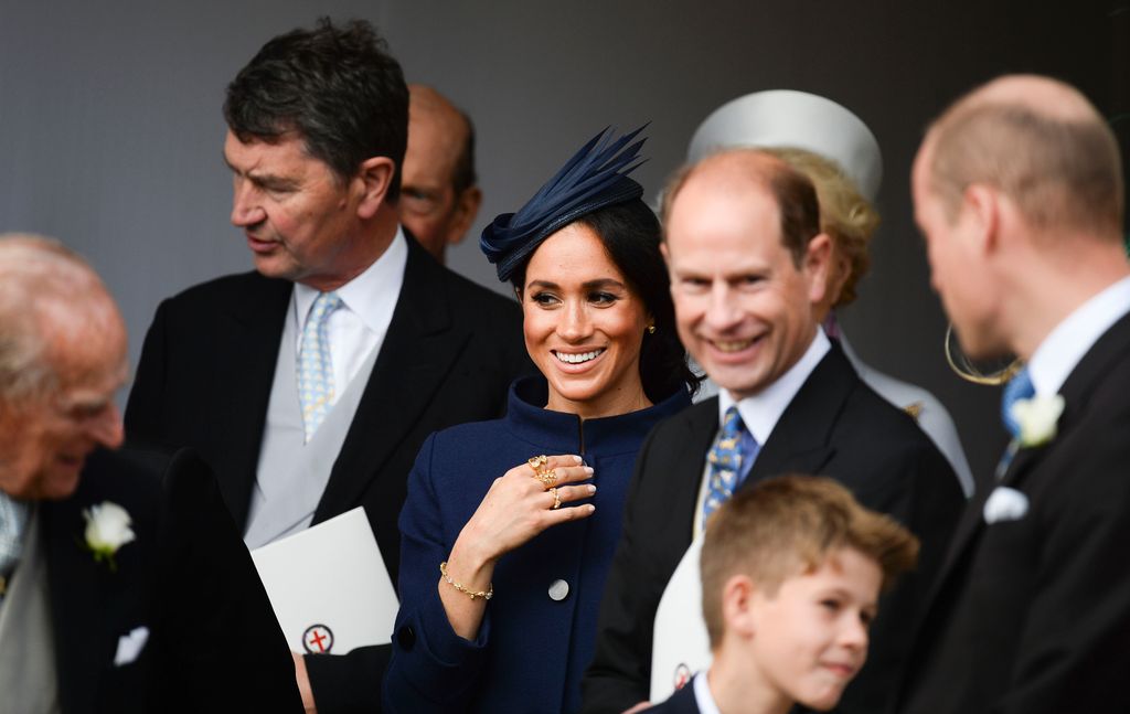 Meghan elevated her wedding guest ensemble with a collection of Pippa Small rings