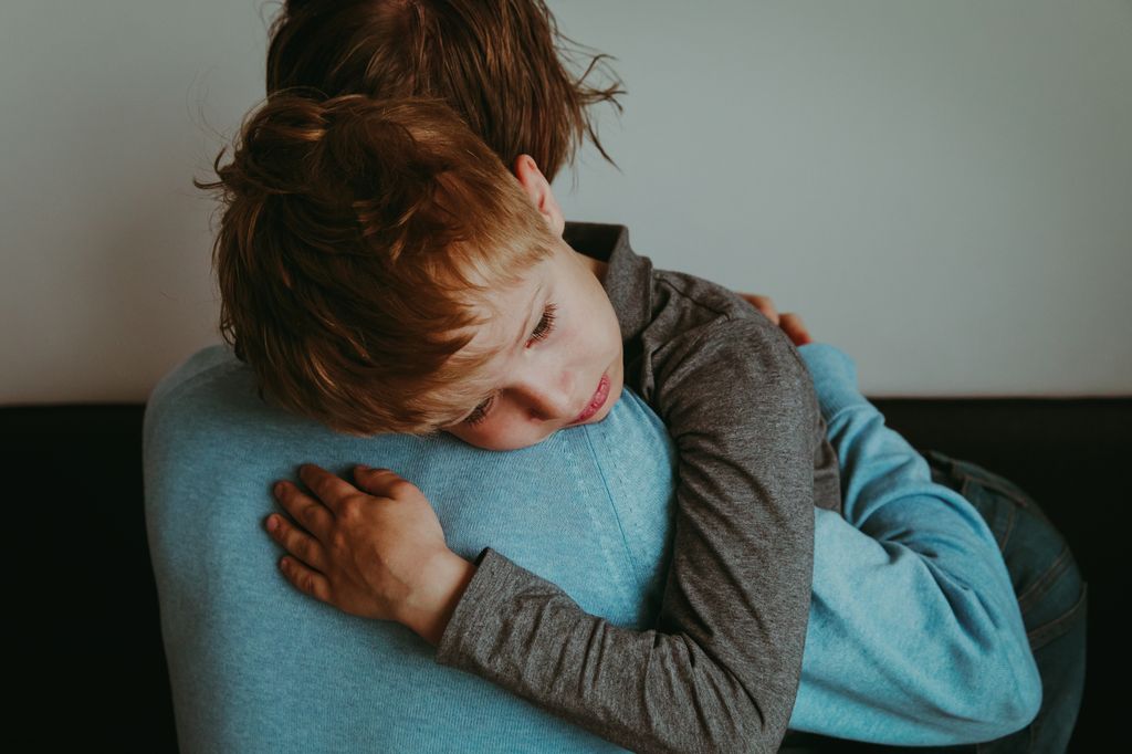 Father comforting sad child