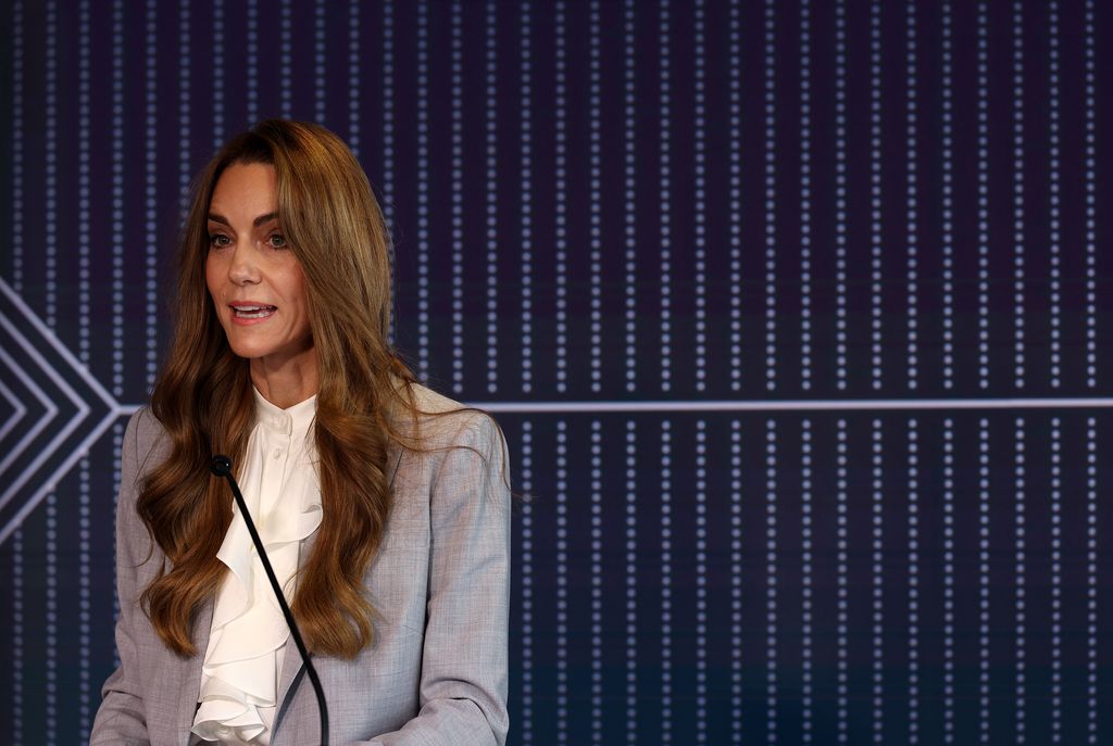 The future Queen took to the stage wearing a white pussy bow blouse and grey suit jacket