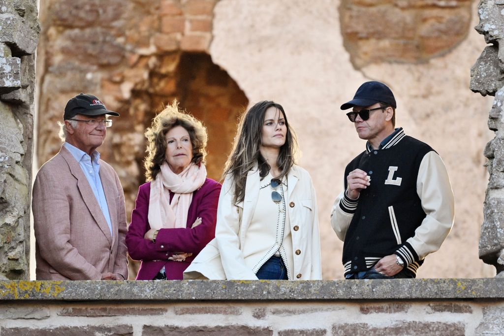 Princess Sofia in a white top with King Carl Gustaf and Queen Silvia