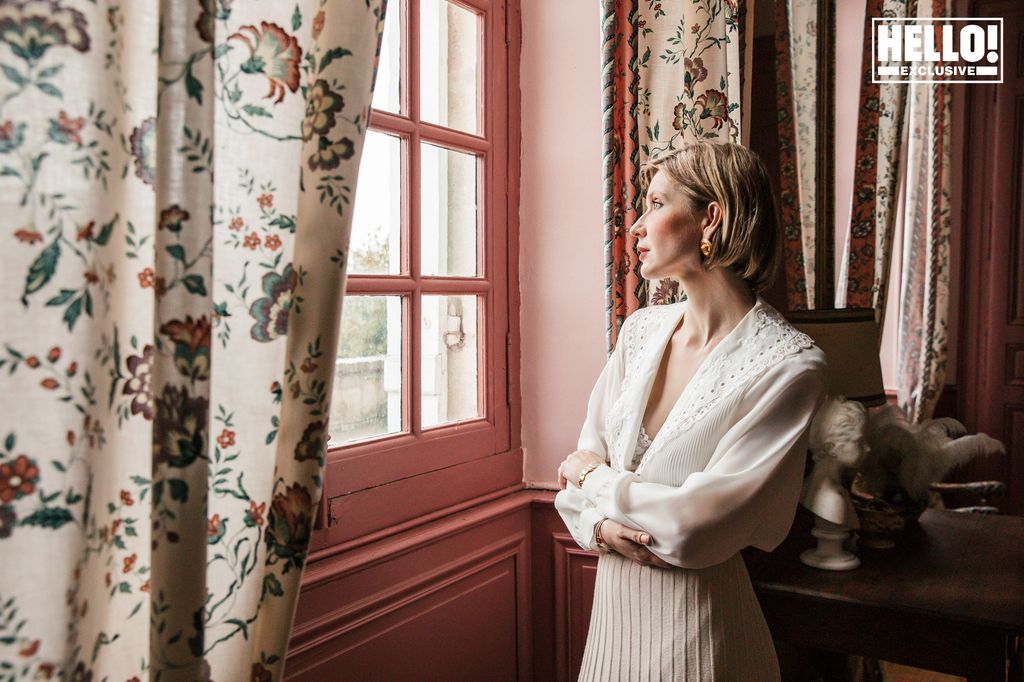 Catherine Roger posing in pink room at Chateau Marcellus near Bordeaux