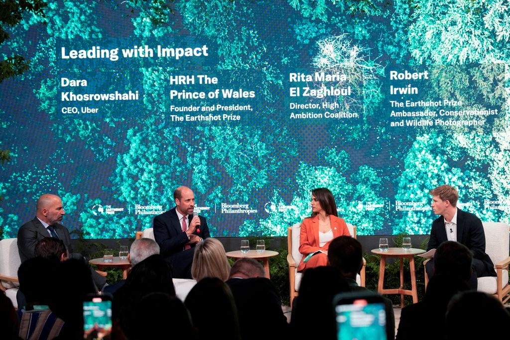 The Prince of Wales, Dara Khosrowshahi, CEO of Uber, Rita Maria El Zaghloul, Director at High Ambition Coalition and Robert Irwin, sit on panel with screen behind them