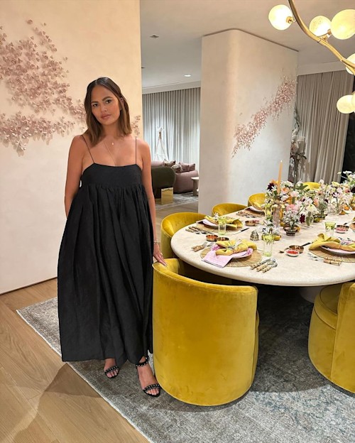 Chrissy by dining room table with yellow chairs