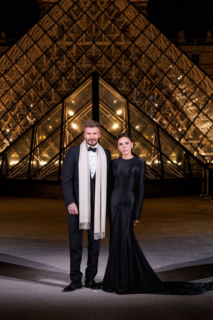 couple posing in front of Louvre