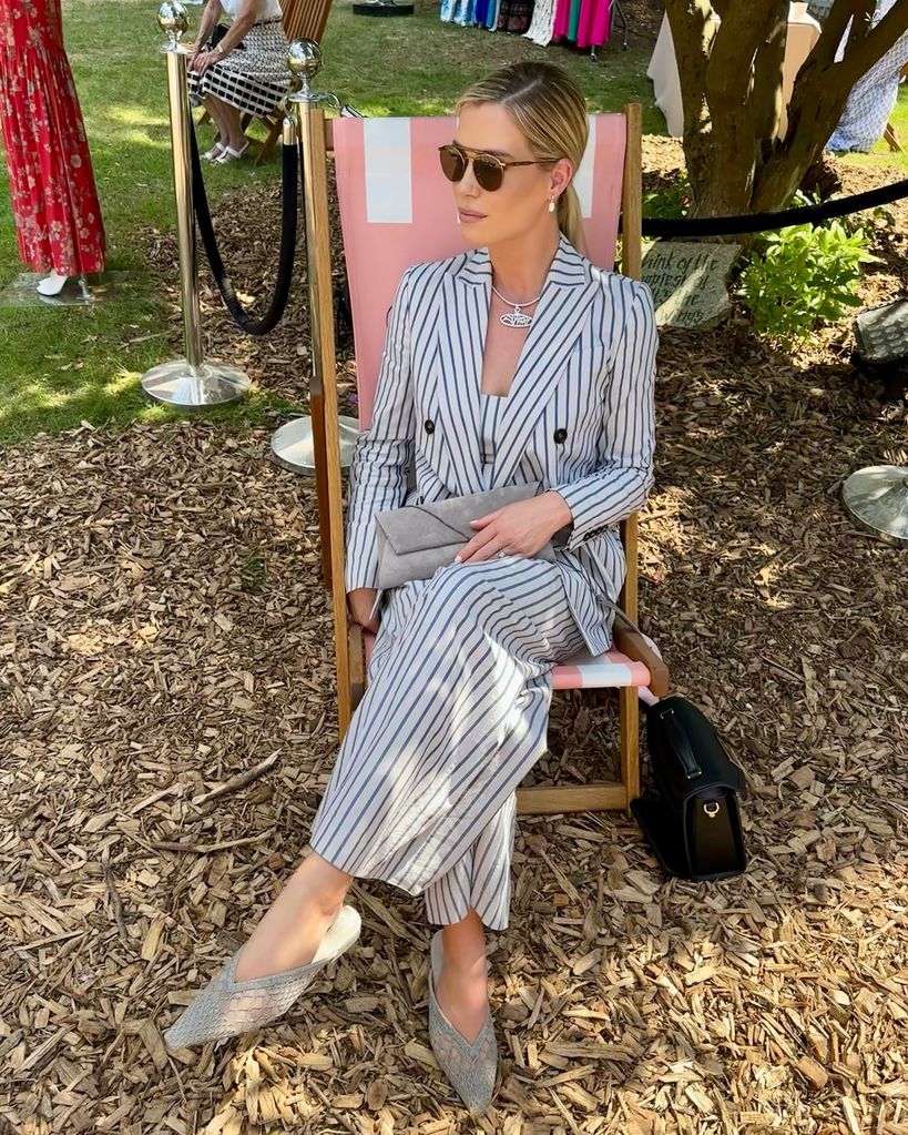 amelia spencer in suit on deck chair
