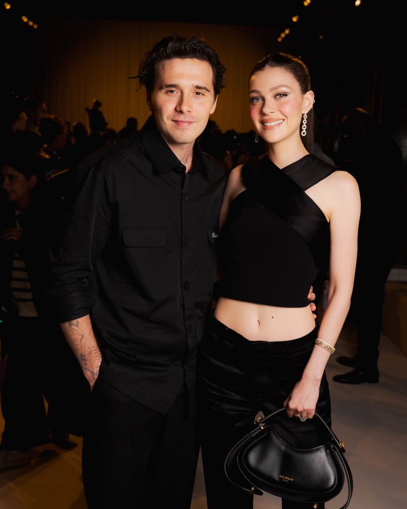 Brookyln Beckham with his arm around Nicola Peltz-Beckham