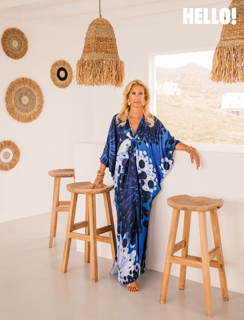 Designer Themis Zouganeli posing by stools and a countertop in her Mykonos home