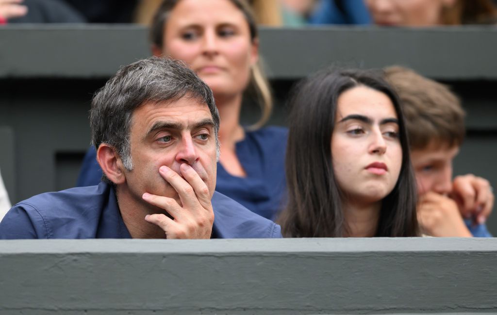 father and daughter watching tennis 