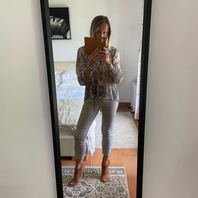 6 a woman stands in front of a full length mirror