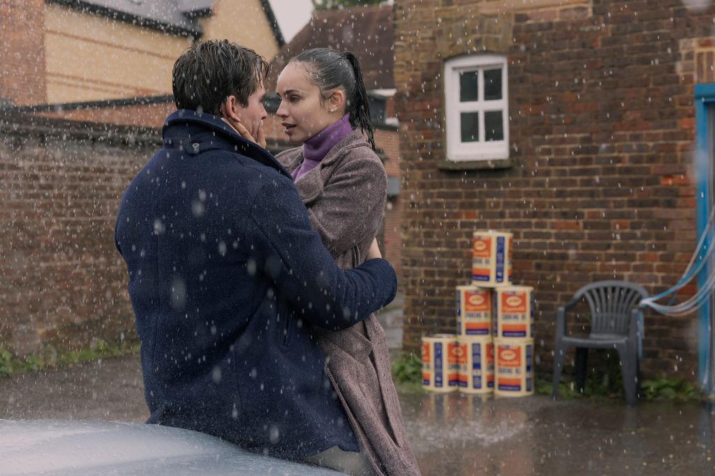 man and woman hugging in rain