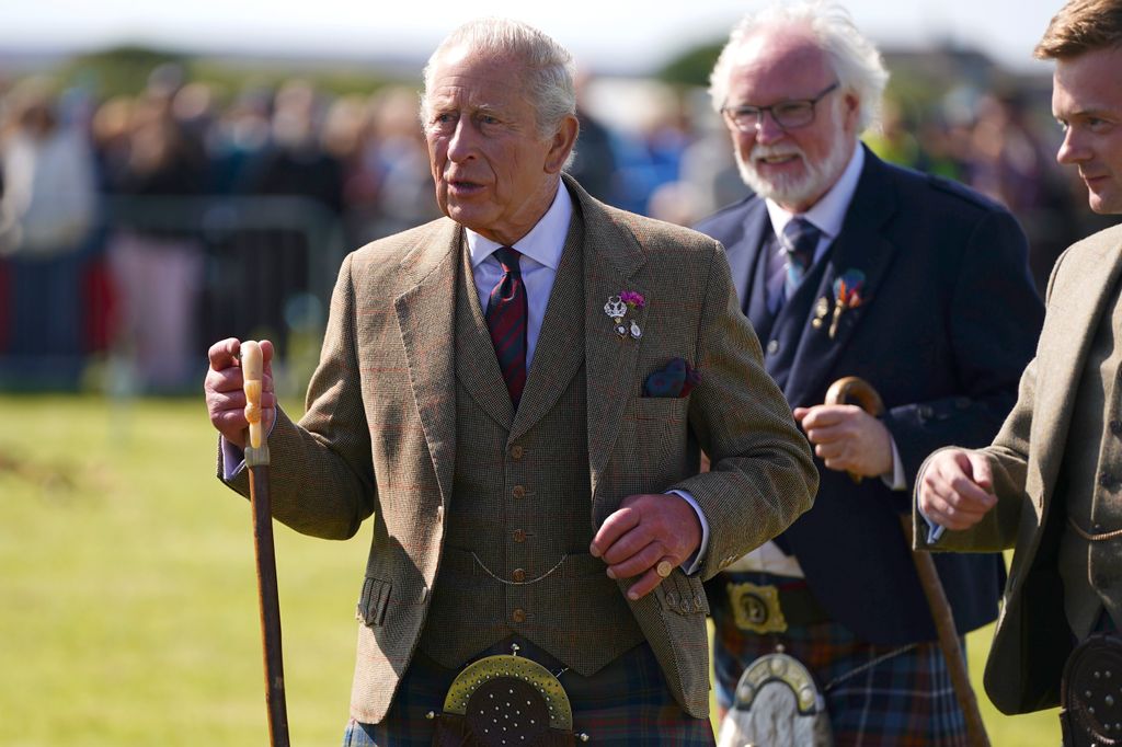 King Charles walking with a walking stick
