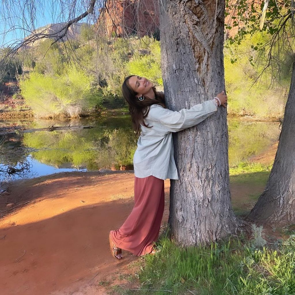 Jessica Alba hugs a tree on Earth Day