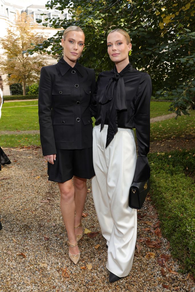 Amelia Spencer and Eliza Spencer pose in  garden